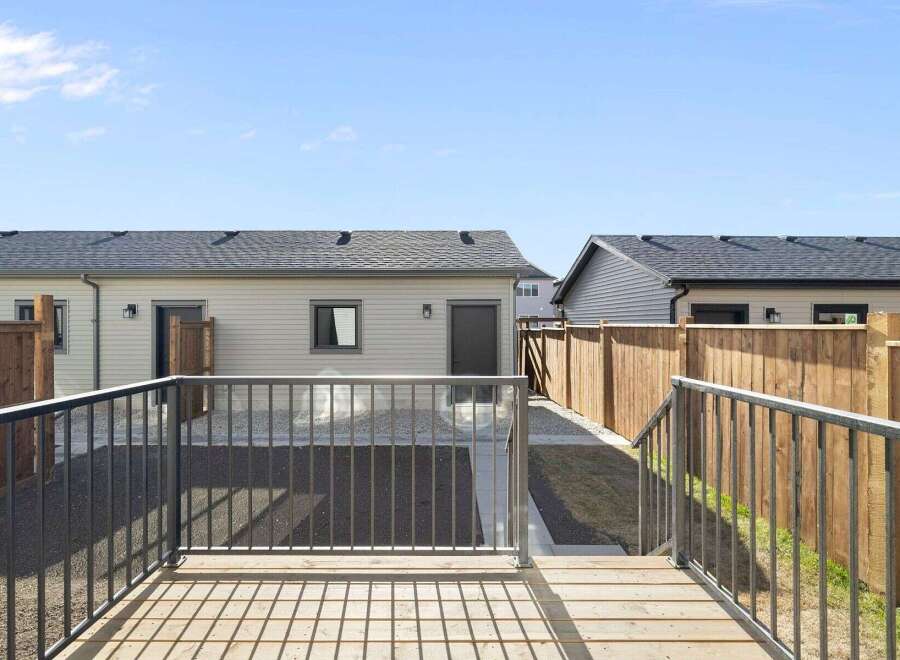Enjoy outdoor living in this beautiful backyard! This property features a spacious deck, perfect for entertaining or relaxing.