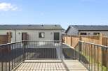 Enjoy outdoor living in this beautiful backyard! This property features a spacious deck, perfect for entertaining or relaxing.