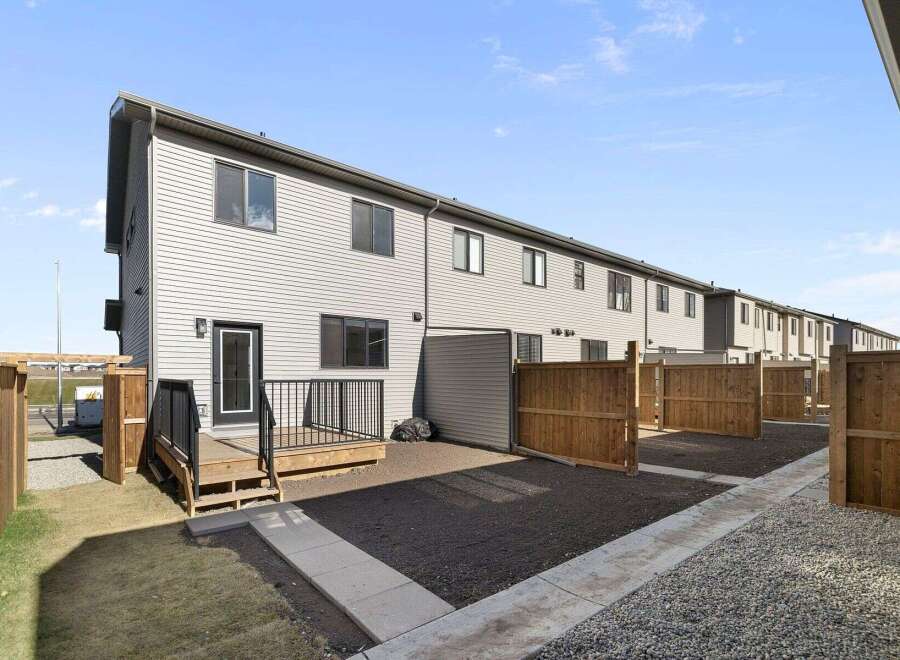 Discover modern living in this stunning townhome, featuring a sleek exterior and a private outdoor space.