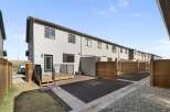 Discover modern living in this stunning townhome, featuring a sleek exterior and a private outdoor space.