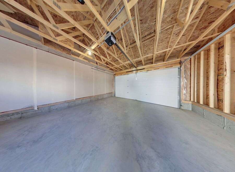 This spacious garage offers ample room for vehicles and storage.