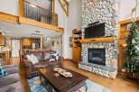 This stunning property boasts a cozy living room with a stone fireplace, perfect for relaxing evenings.