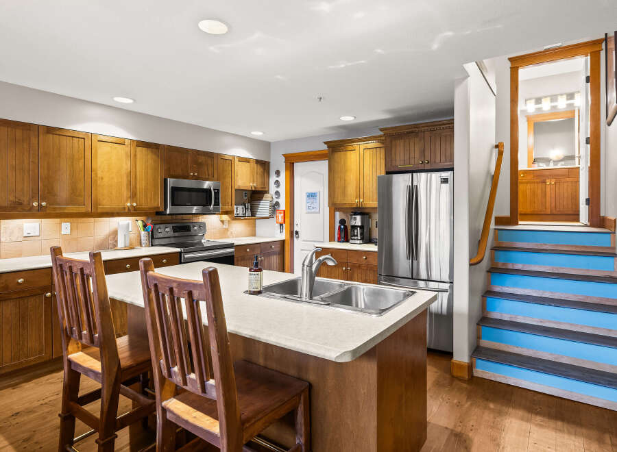 This stunning kitchen boasts beautiful wooden cabinetry and a spacious island, perfect for both cooking and entertaining.