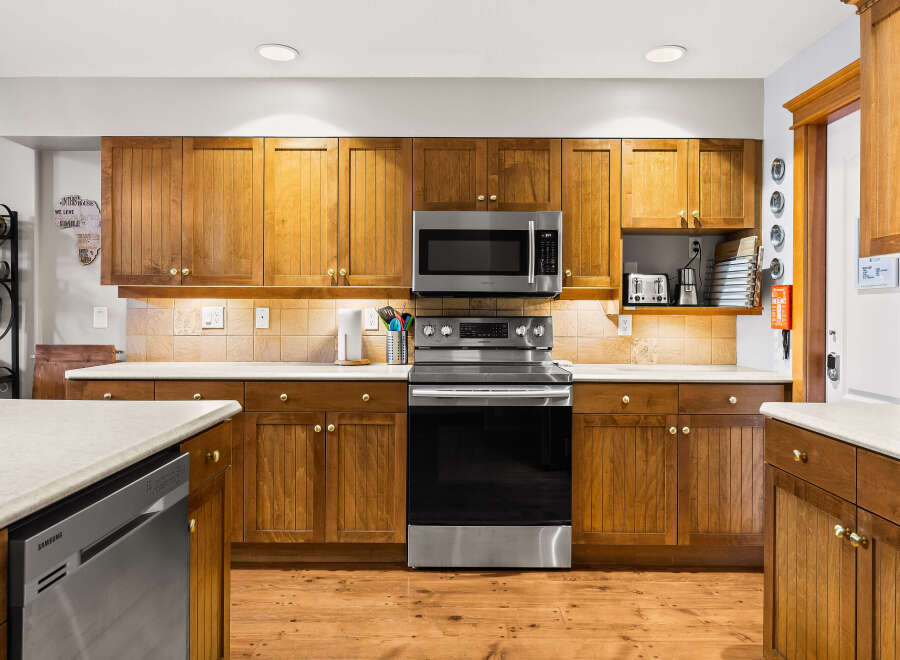 This stunning kitchen boasts beautiful wooden cabinetry, offering ample storage and a warm, inviting atmosphere.