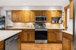 This stunning kitchen boasts beautiful wooden cabinetry, offering ample storage and a warm, inviting atmosphere.