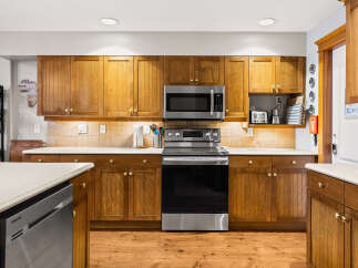 This stunning kitchen boasts beautiful wooden cabinetry, offering ample storage and a warm, inviting atmosphere.