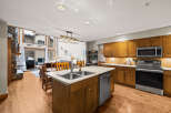 This stunning kitchen boasts a spacious island with a double sink and a modern stainless steel dishwasher.