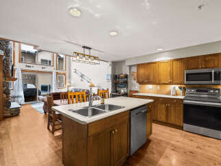 This stunning kitchen boasts a spacious island with a double sink and a modern stainless steel dishwasher.
