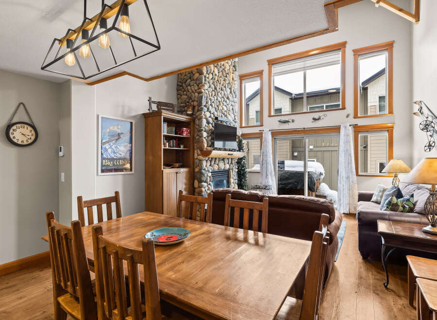 This stunning property boasts a cozy living space with a stone fireplace, perfect for those chilly evenings.
