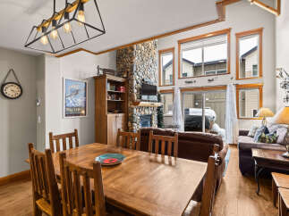 This stunning property boasts a cozy living space with a stone fireplace, perfect for those chilly evenings.