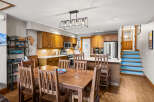 This stunning kitchen and dining area is the heart of the home, featuring beautiful wooden cabinetry and a spacious layout.