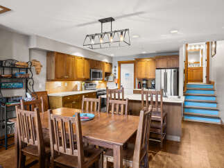 This stunning kitchen and dining area is the heart of the home, featuring beautiful wooden cabinetry and a spacious layout.