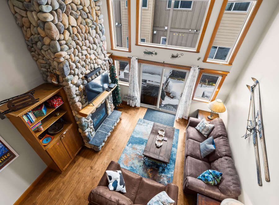 This stunning living room features a cozy stone fireplace, perfect for those chilly evenings.