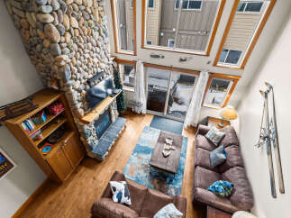 This stunning living room features a cozy stone fireplace, perfect for those chilly evenings.