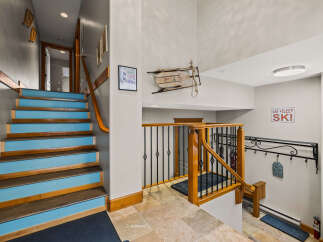 This stunning property boasts a welcoming entryway with a unique staircase design, perfect for making a grand first impression.