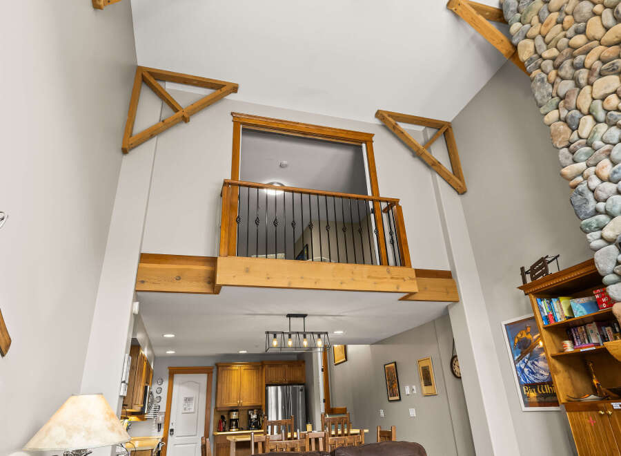 This stunning property boasts a unique architectural design with high ceilings and exposed wooden beams, creating a spacious and inviting atmosphere.