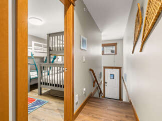 Step into this inviting space, featuring a cozy bunk bed setup perfect for family or guests.