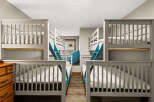This charming bedroom features two sets of bunk beds, perfect for accommodating multiple guests or family members.