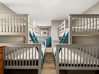 This charming bedroom features two sets of bunk beds, perfect for accommodating multiple guests or family members.