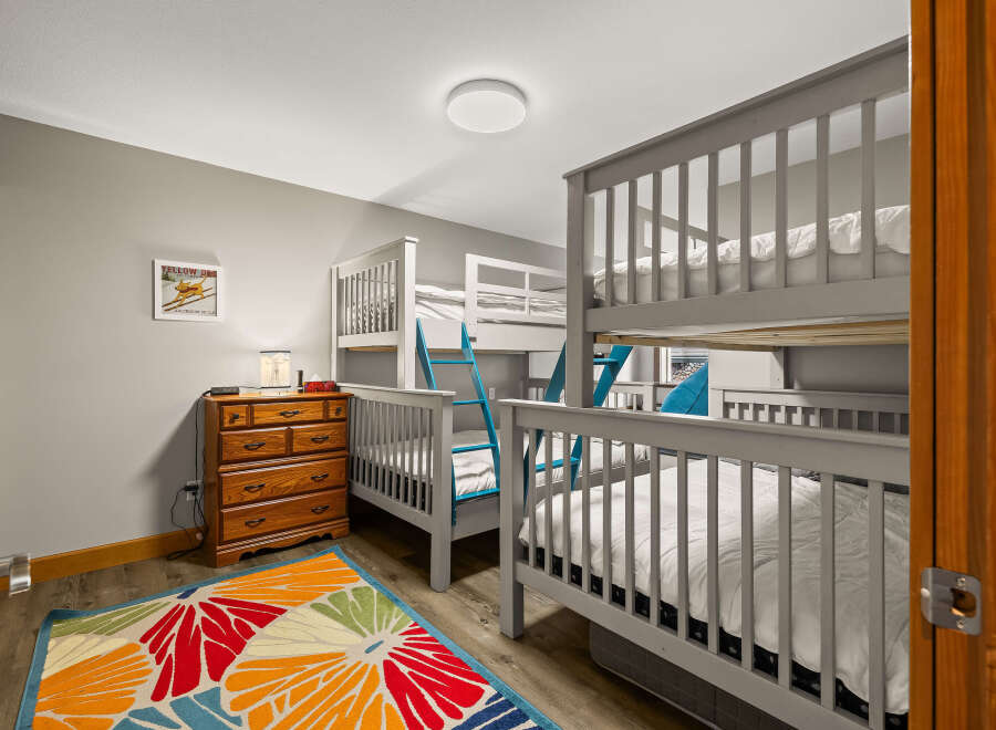 This charming bedroom features multiple bunk beds, perfect for accommodating a large family or group.