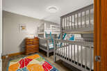 This charming bedroom features multiple bunk beds, perfect for accommodating a large family or group.