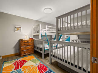 This charming bedroom features multiple bunk beds, perfect for accommodating a large family or group.