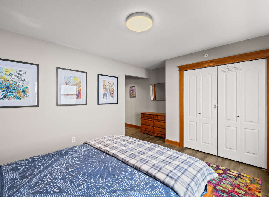 This cozy bedroom features a comfortable bed with a stylish blue and white patterned duvet.