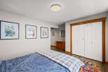 This cozy bedroom features a comfortable bed with a stylish blue and white patterned duvet.