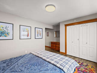 This cozy bedroom features a comfortable bed with a stylish blue and white patterned duvet.