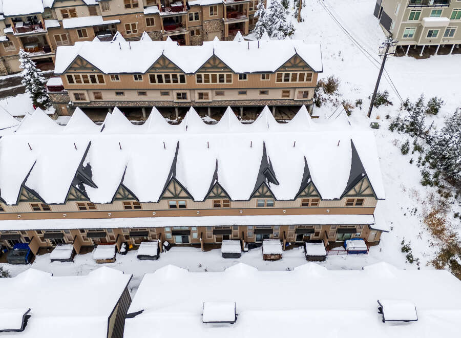 Discover the charm of this snow-covered mountain property, perfect for a winter getaway.