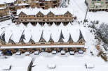 Discover the charm of this snow-covered mountain property, perfect for a winter getaway.
