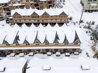 Discover the charm of this snow-covered mountain property, perfect for a winter getaway.
