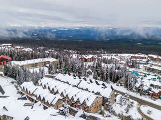 Discover a winter wonderland in this stunning mountain property! This home boasts cozy interiors, perfect for enjoying snowy days.