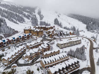 Nestled amidst a snowy mountain landscape, this property offers a serene retreat.