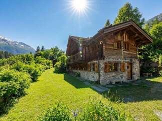 Nestled in a serene landscape, this charming wooden chalet offers a perfect blend of rustic elegance and modern comfort.