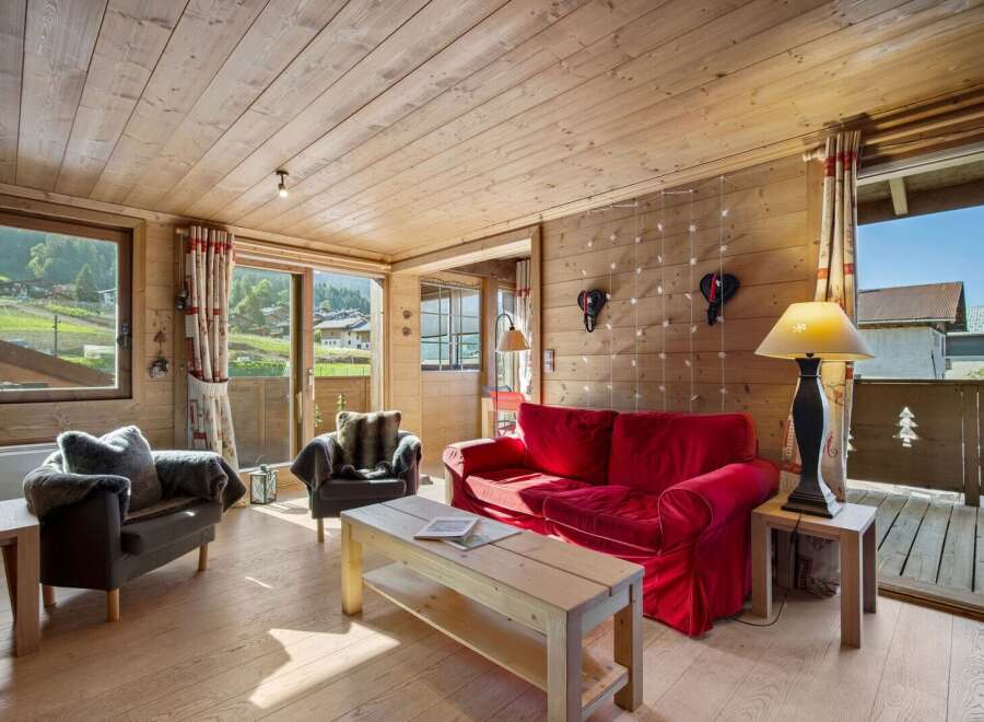 Experience the charm of this cozy chalet, featuring a warm wooden interior and stunning mountain views.