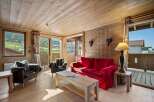 Experience the charm of this cozy chalet, featuring a warm wooden interior and stunning mountain views.