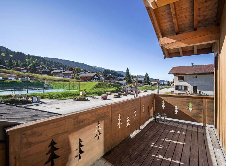 Enjoy breathtaking views from this charming balcony overlooking a picturesque village.