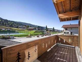 Enjoy breathtaking views from this charming balcony overlooking a picturesque village.