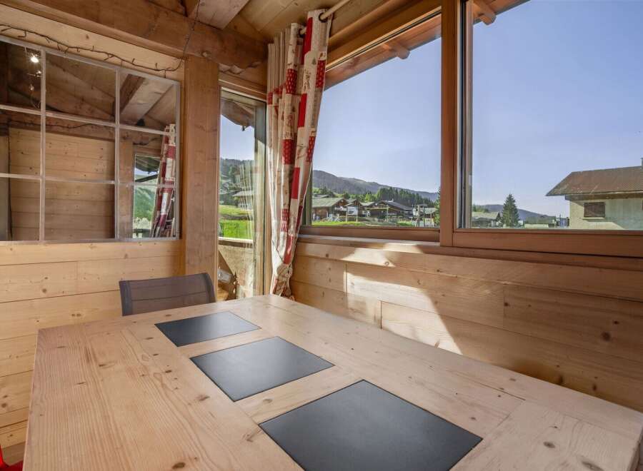 Enjoy breathtaking mountain views from this cozy cabin dining area.