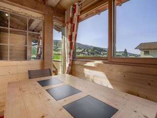 Enjoy breathtaking mountain views from this cozy cabin dining area.