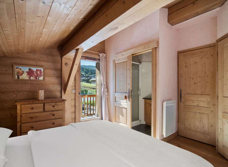 Experience the charm of this cozy bedroom, featuring stunning wooden accents and a serene ambiance.