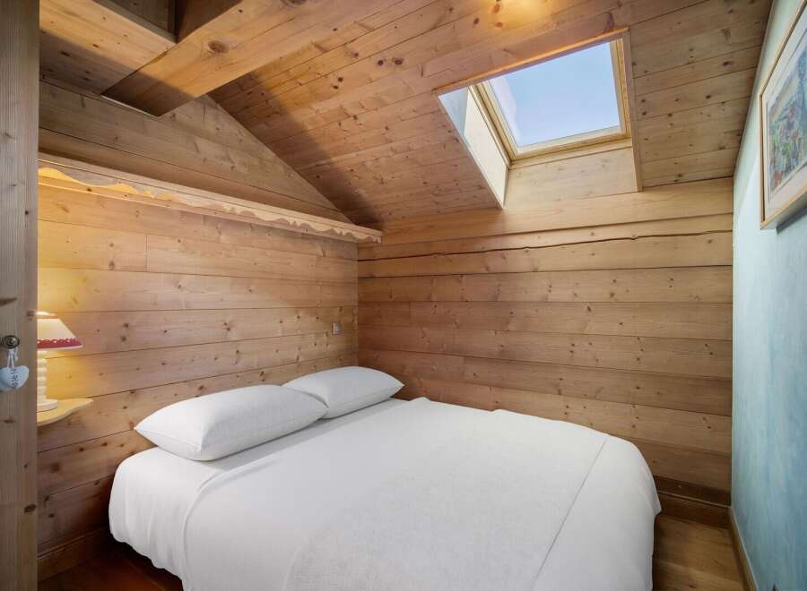 This cozy bedroom features a unique wooden design, creating a warm and inviting atmosphere.