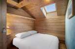 This cozy bedroom features a unique wooden design, creating a warm and inviting atmosphere.