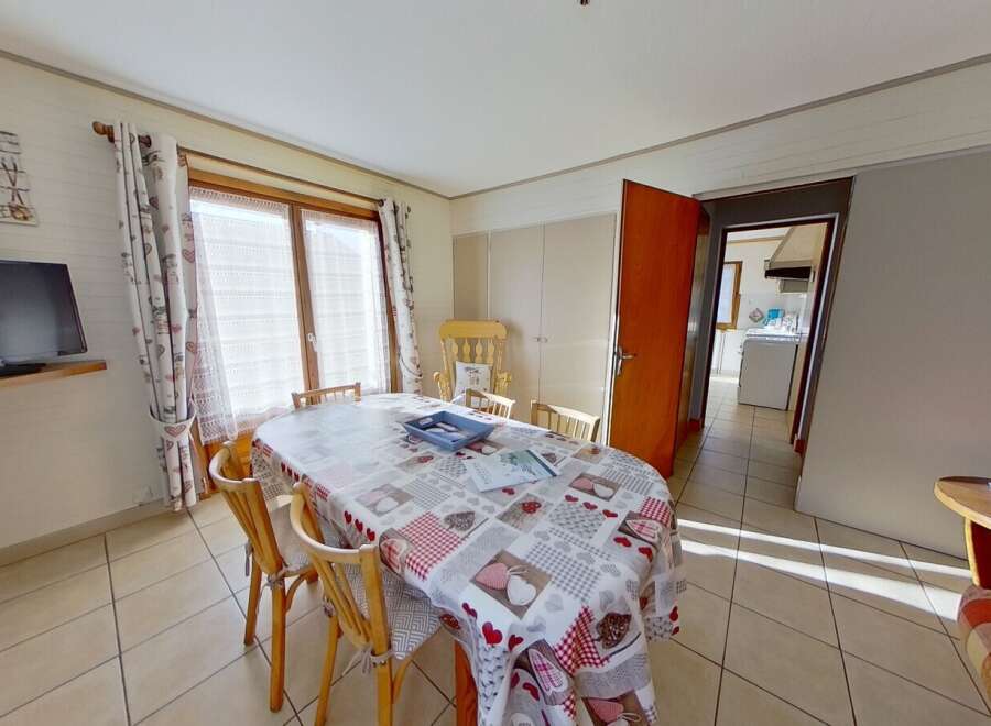 This charming dining area features a cozy atmosphere with a large oval table, perfect for family gatherings.