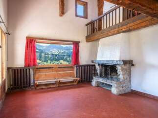 Experience the charm of this stunning property, featuring a cozy fireplace and a breathtaking mountain view.