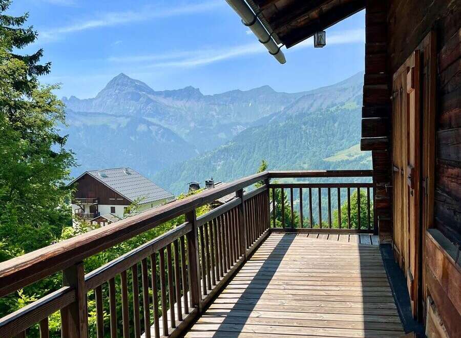 Enjoy breathtaking mountain views from this charming wooden balcony.