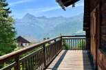 Enjoy breathtaking mountain views from this charming wooden balcony.