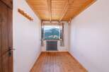 This charming room offers stunning mountain views through a large window, creating a serene and inviting atmosphere.