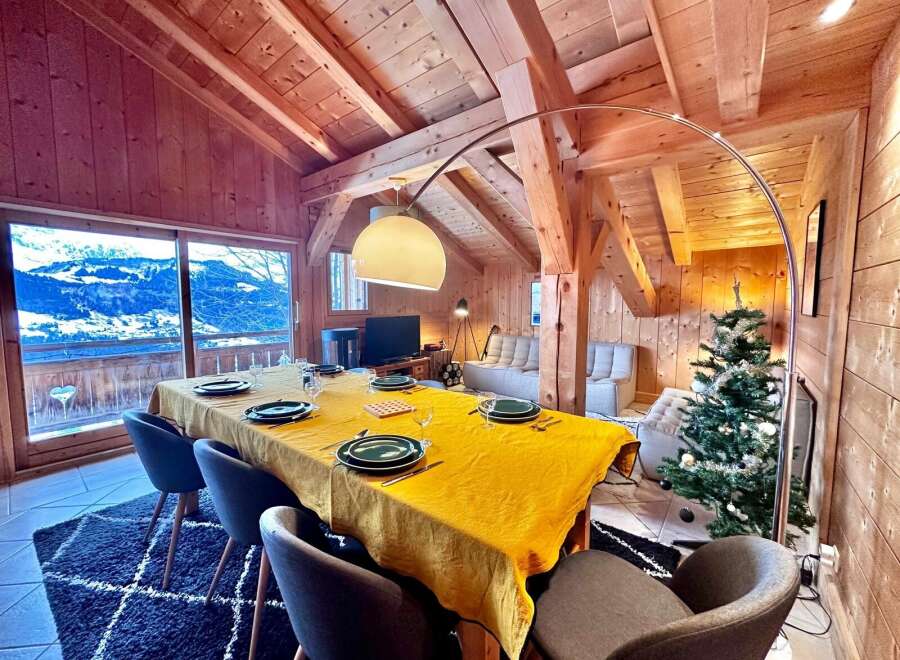 Experience the charm of this stunning chalet, featuring a cozy dining area perfect for gatherings.